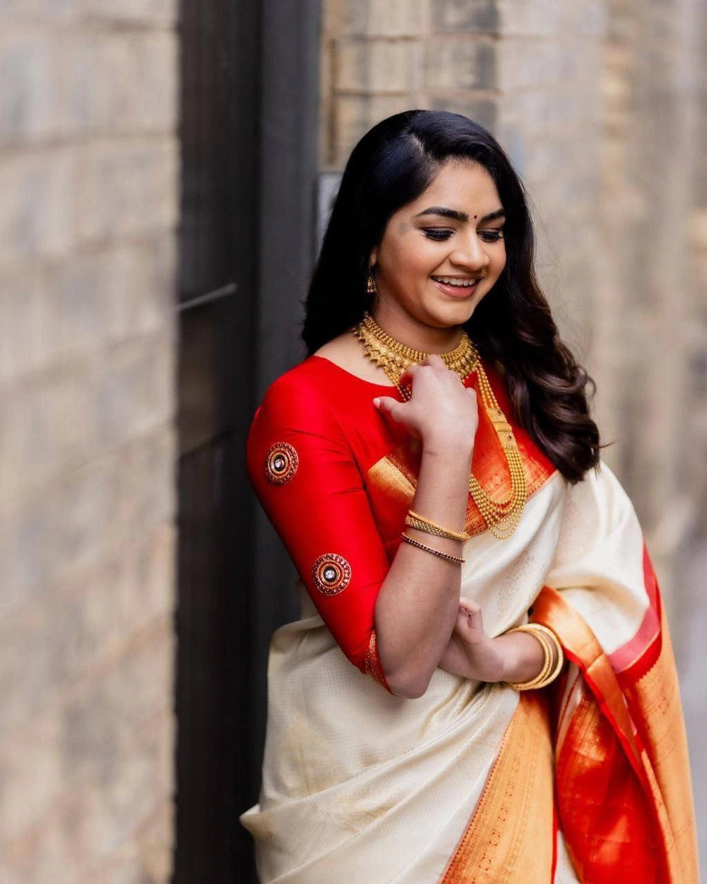 Cream art silk saree pleats and red zari border on model – Kalyanja KS409