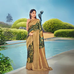 Woman in a dark green zari work saree featuring elegant floral design and rich golden border, posing gracefully by the poolside in ethnic jewelry