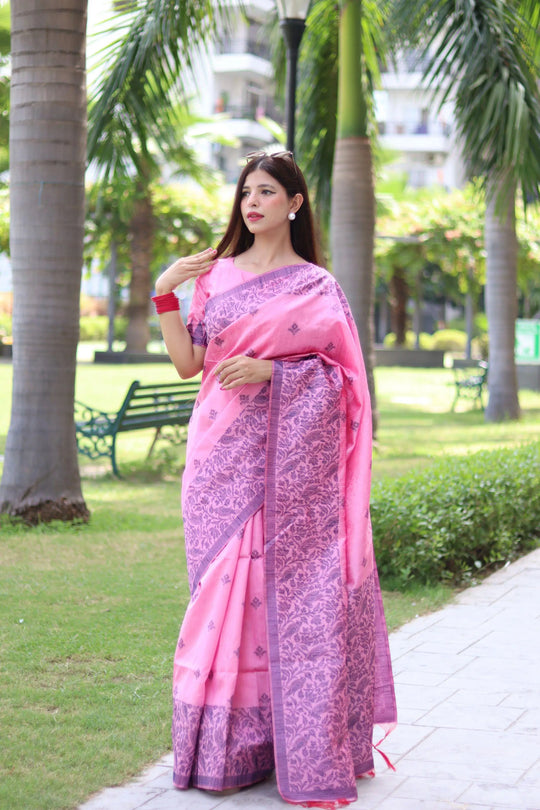Woman in light pink traditional weaving saree showcasing elegant ethnic style in garden background