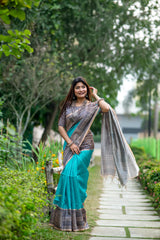 Teal Madhubani print saree with intricate traditional Indian artwork and ethnic detailing