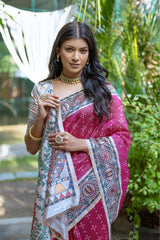 A woman models a vibrant Dark Pink Tussar Silk Saree with small scattered prints. The pallu features a wide, elaborate panel with intricate Madhubani-style folk art prints in white, red, pink, and green. She wears a cream/gold embellished blouse and a gold Kundan choker necklace.