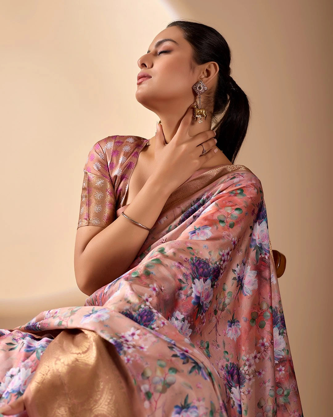 Soft pink lichi silk saree featuring a vibrant floral digital print, an elegant gold zari woven border, and tassel details by Kalyanja.