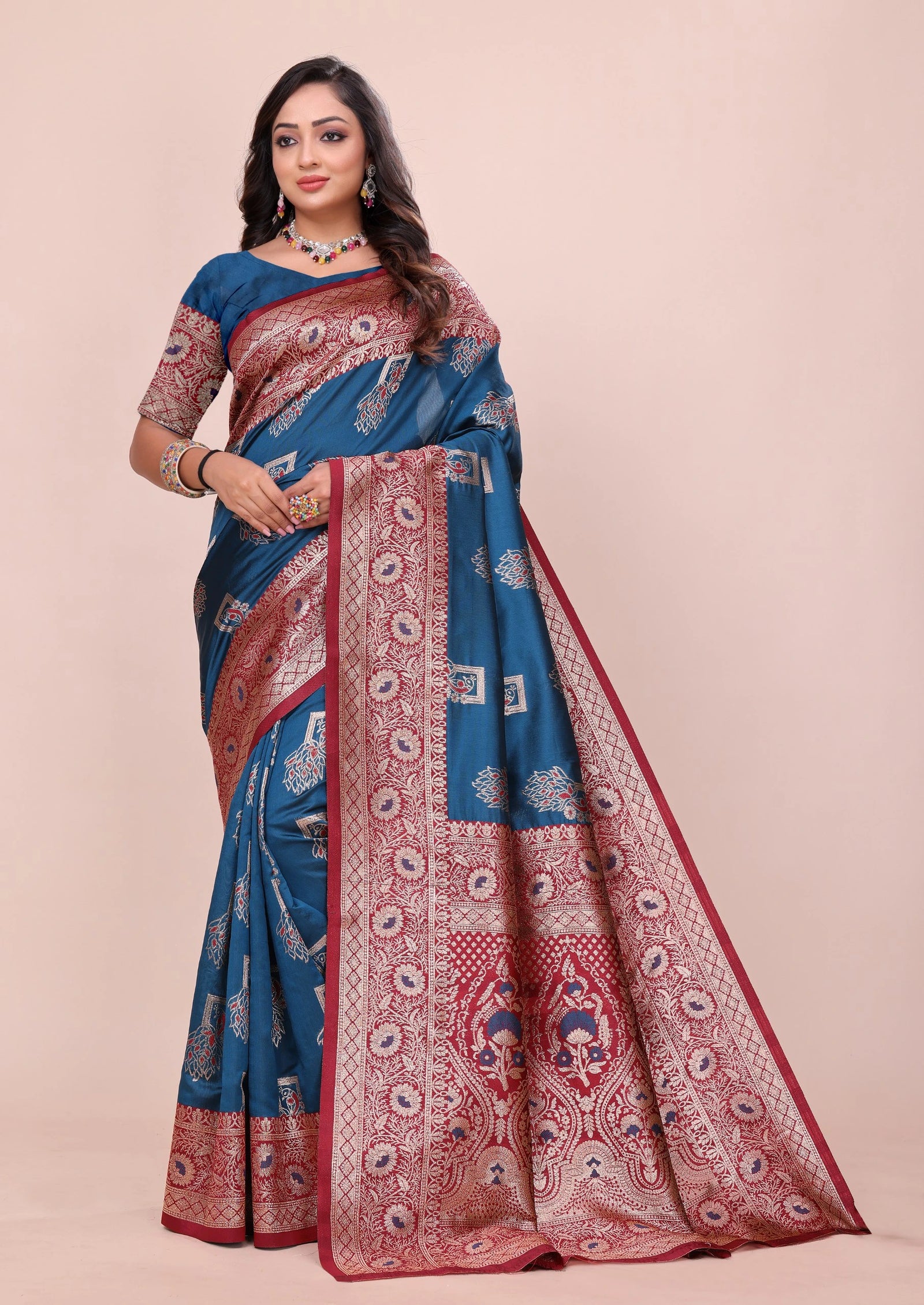 Teal blue Avni silk saree featuring intricate copper-toned zari weaving and a rich maroon pallu by Kalyanja.