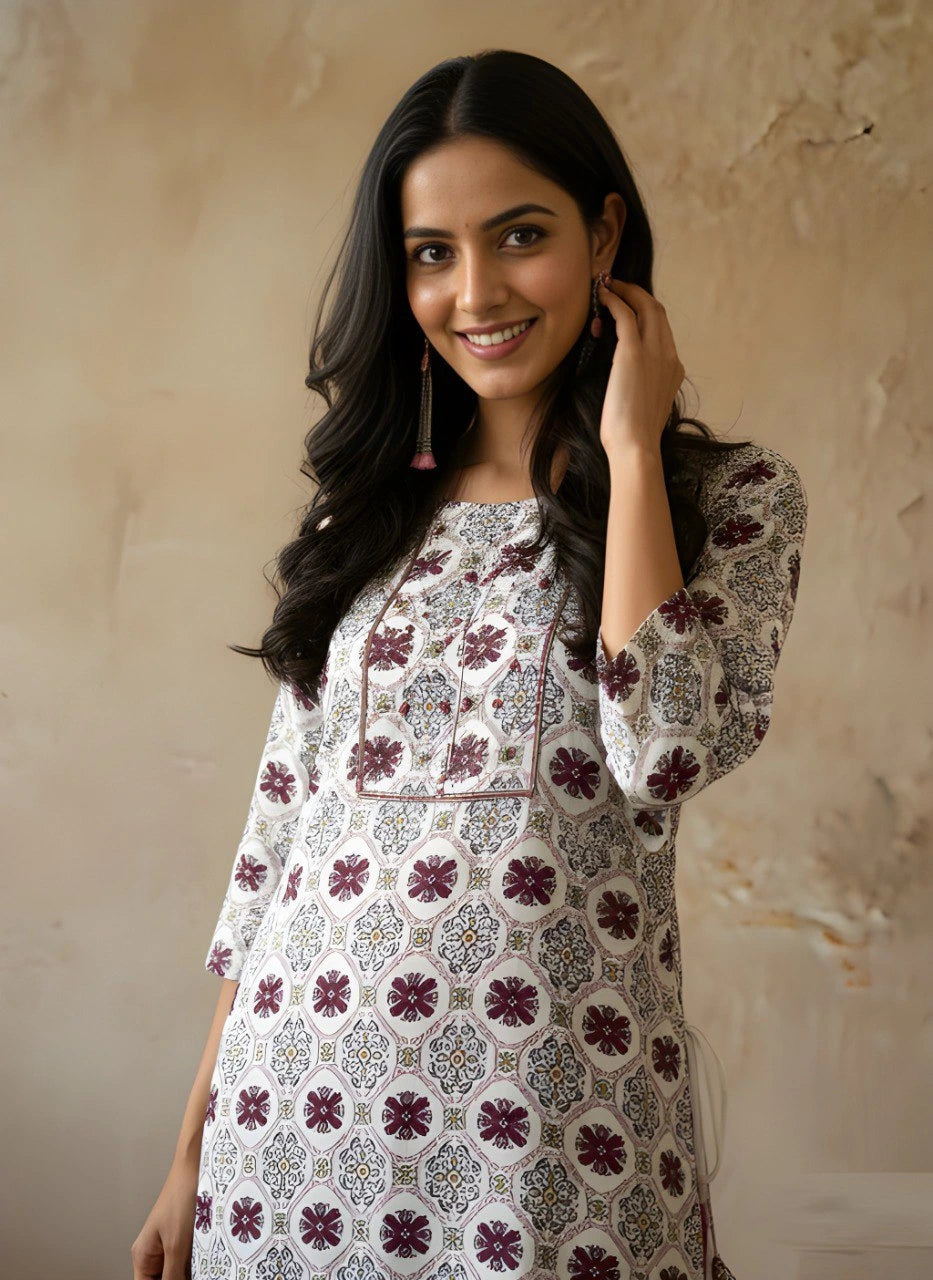 Woman wearing a patterned kurta against a beige wall
