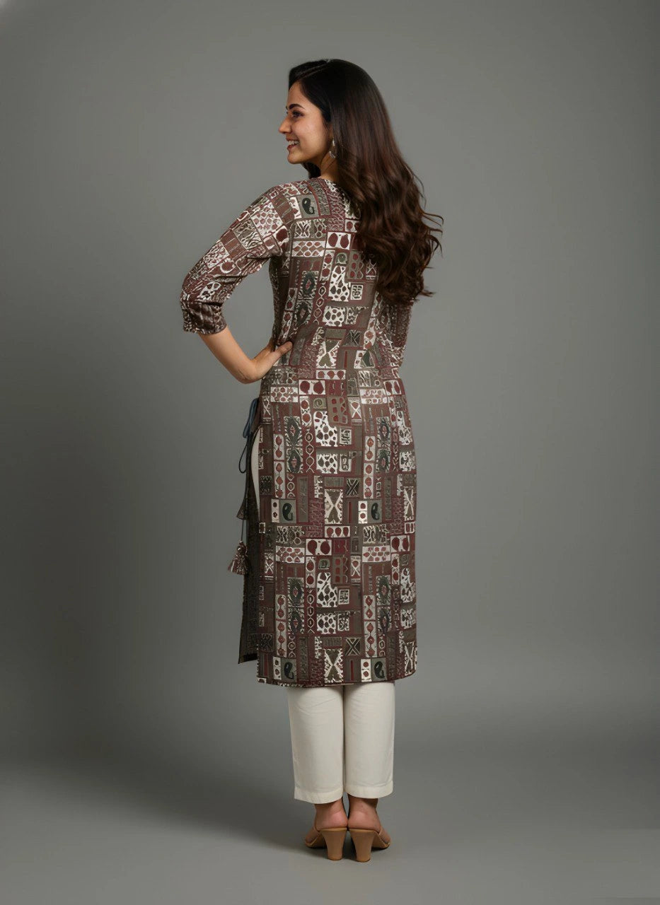 Woman wearing a patterned kurta with white pants against a gray background
