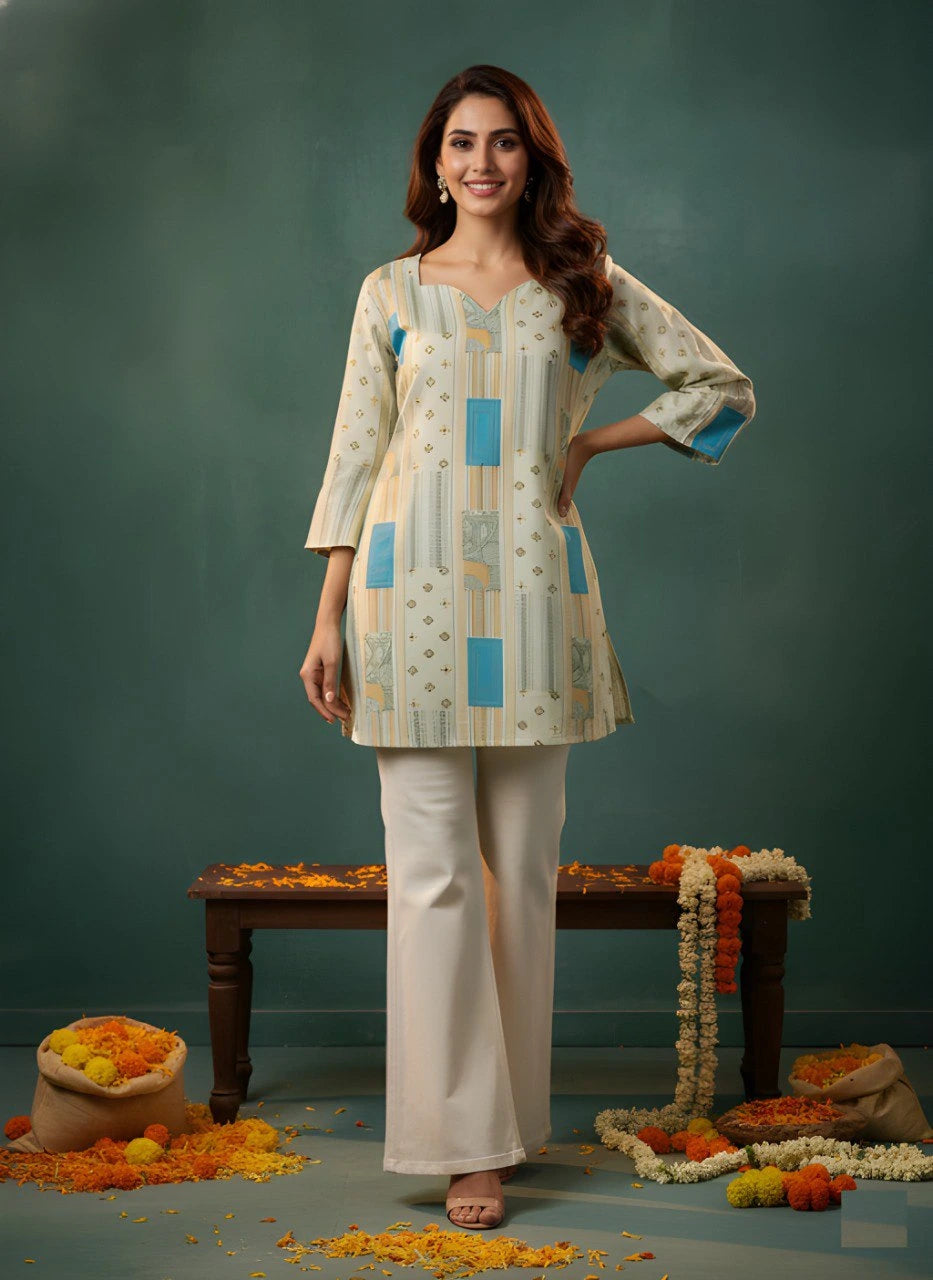 Woman wearing a patterned kurta with white pants against a green background