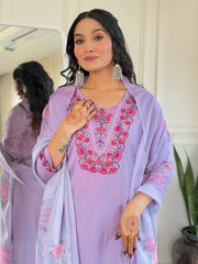 Woman wearing a light purple embroidered outfit with a matching dupatta, standing in front of a mirror.