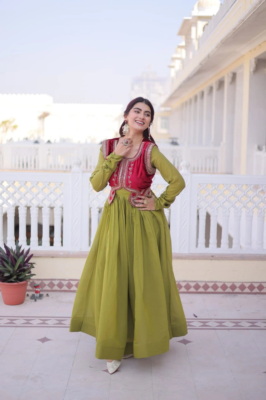 Woman in a green and red traditional outfit standing on a balcony.