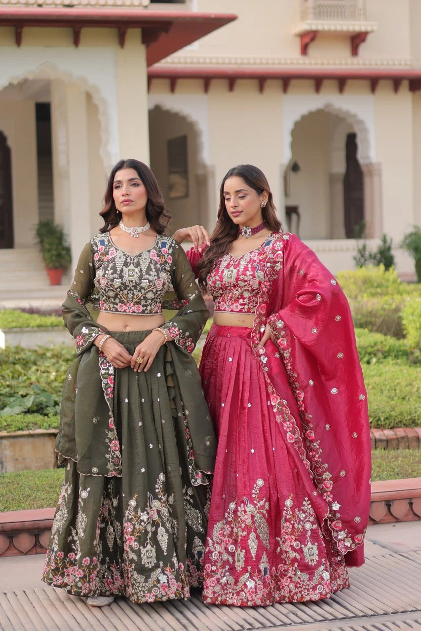 Two women in traditional outfits standing outdoors with a building in the background