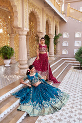 Two women in traditional Indian attire standing in an ornate indoor setting.