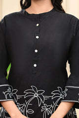 Black kurta with white floral embroidery on a neutral background