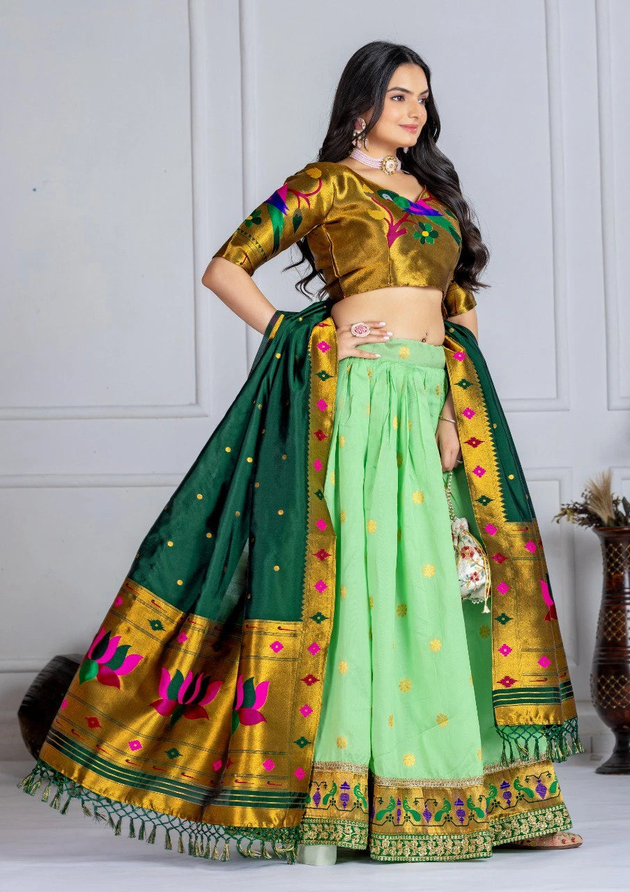 Woman wearing a green and gold traditional outfit with a white background