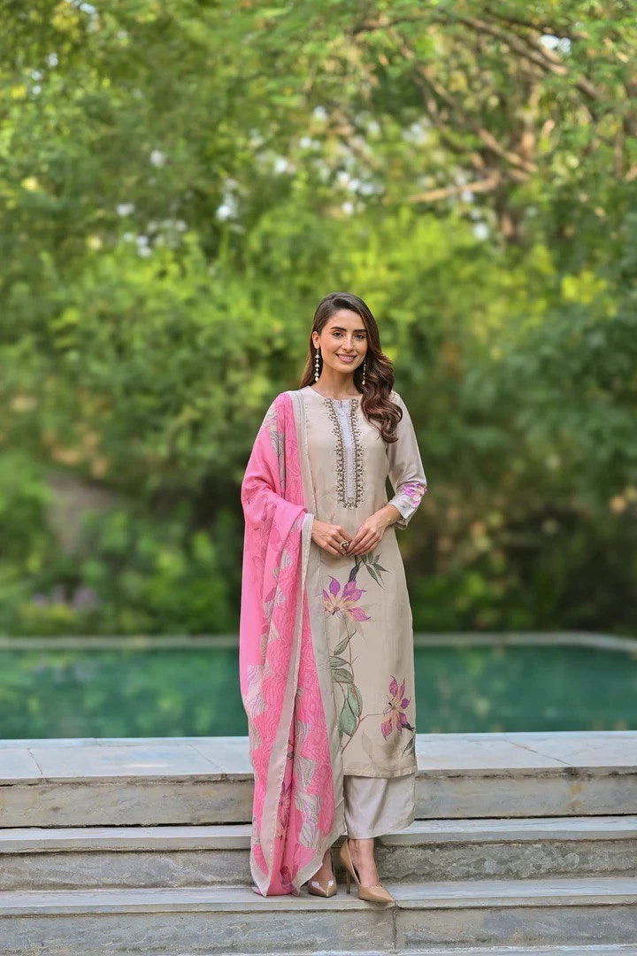 Woman in traditional outfit with pink dupatta standing outdoors