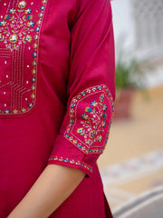Close-up of a pink garment with intricate embroidery on a blurred background