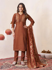 Woman in a brown traditional outfit with a matching dupatta on a white background