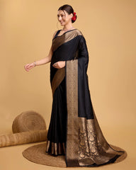 Woman wearing a black saree with gold border on a beige background