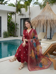 Woman in a red dress with a floral scarf by a poolside