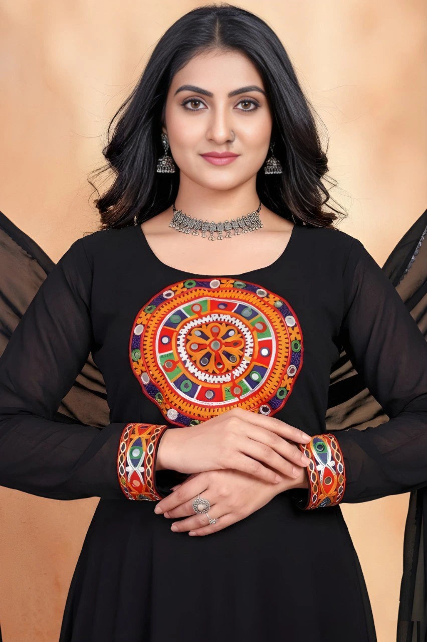 Woman wearing a black outfit with a colorful circular design on a beige background