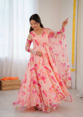 Woman wearing a pink floral dress in a bright room