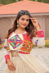 Woman wearing a colorful traditional outfit with intricate patterns.