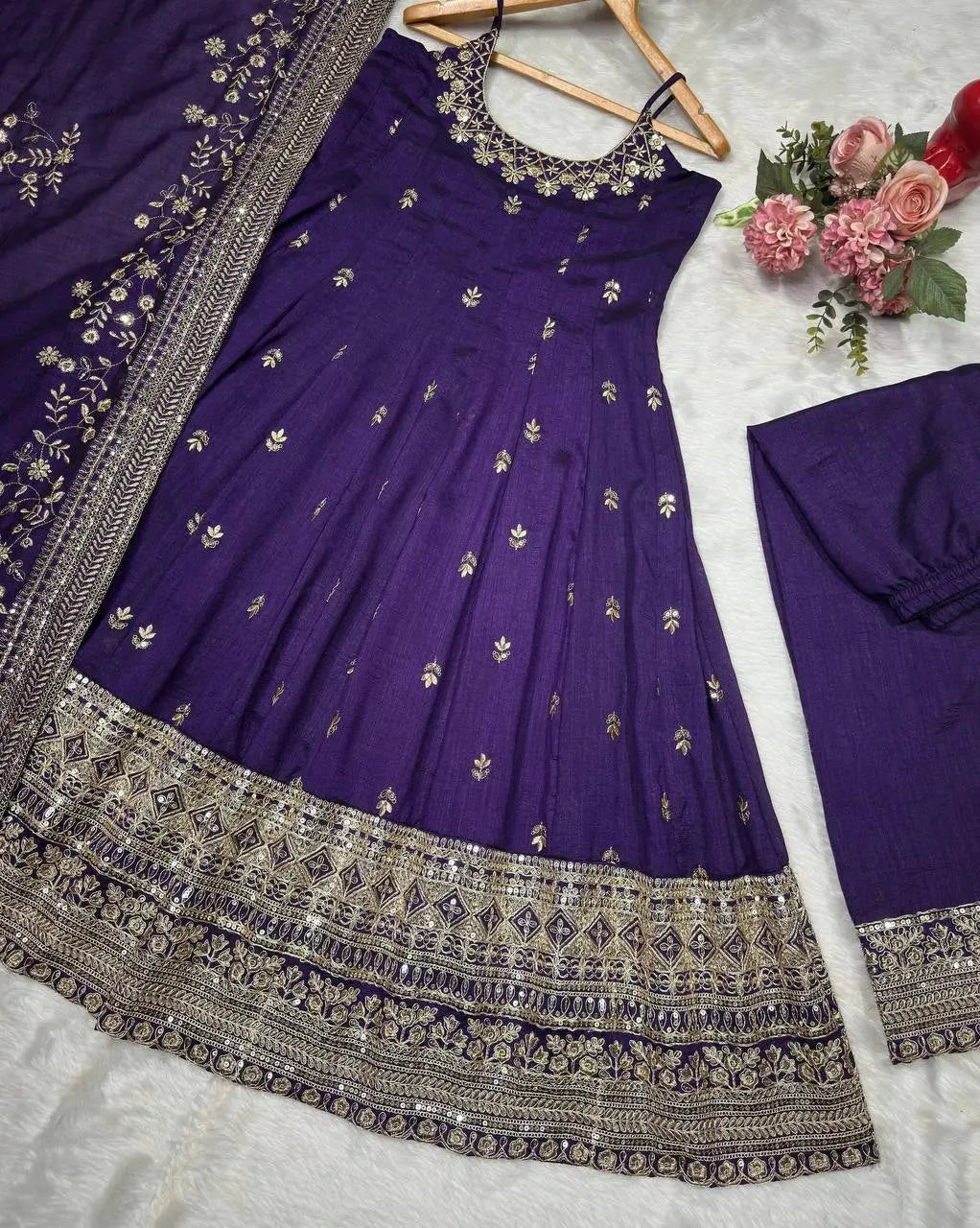 Purple embroidered dress with silver details on a white background