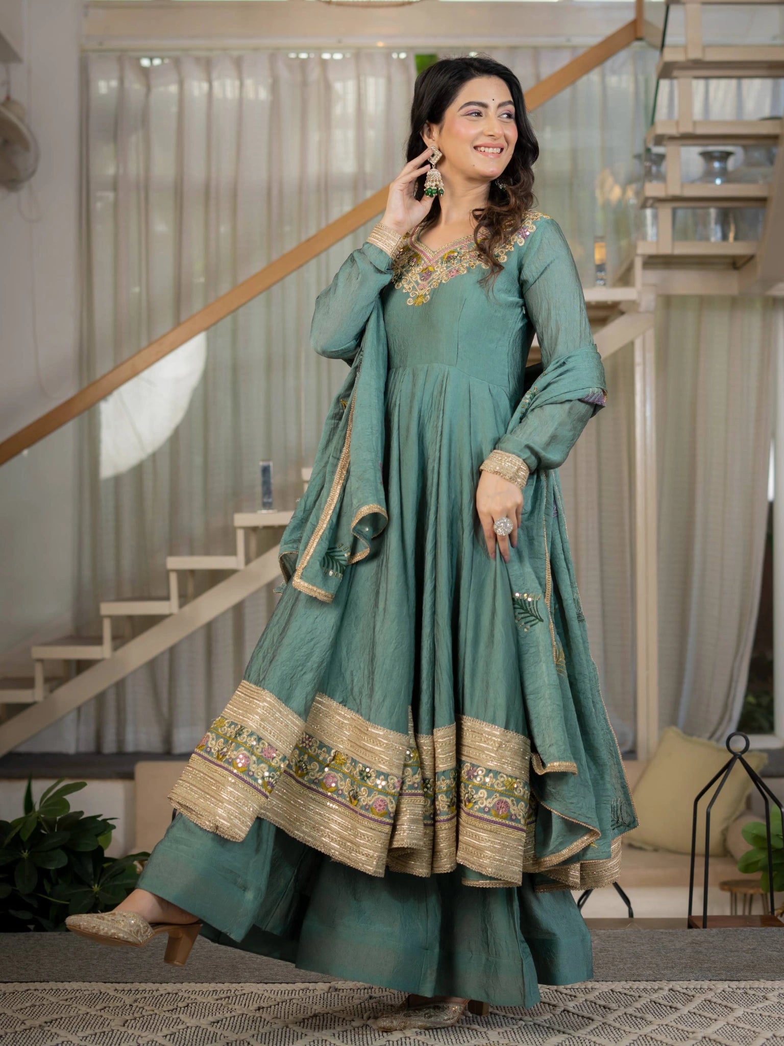 Teal Green Sequins Embroidered Suit full length looking up hand to ear – Kalyanja KU282