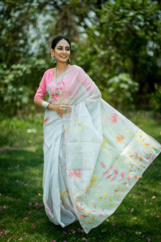 White saree featuring intricate pattern print, showcasing traditional handloom textile craftsmanship