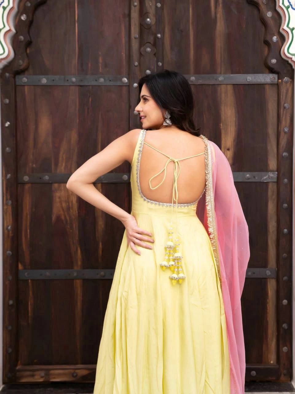 Yellow Fancy Lace Work Anarkali Suit model back view deep open back with tie-up straps – Kalyanja KU294