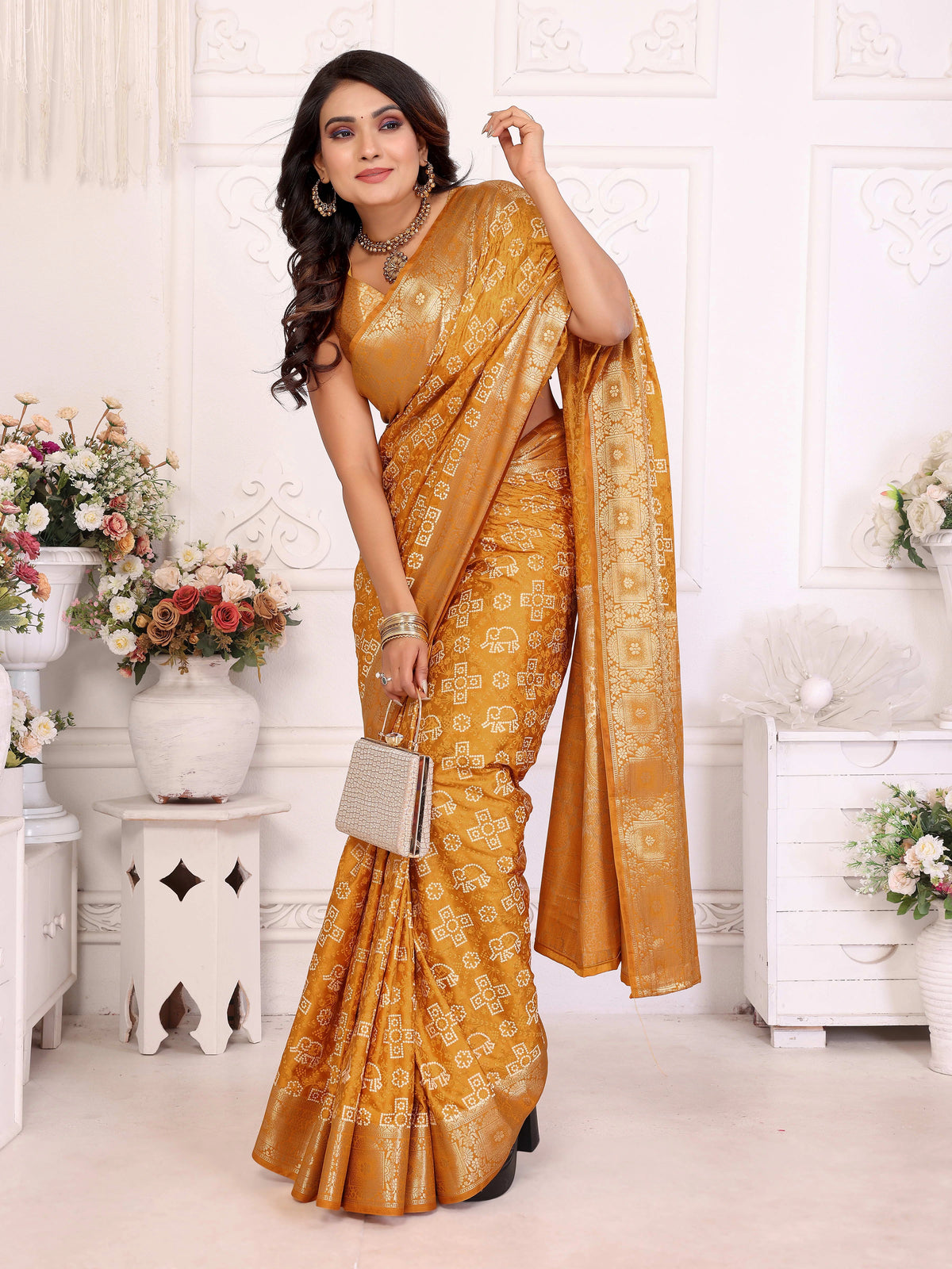 Woman in a mustard yellow saree with a white background