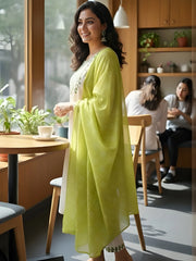 Woman in a bright yellow outfit standing in a modern cafe.