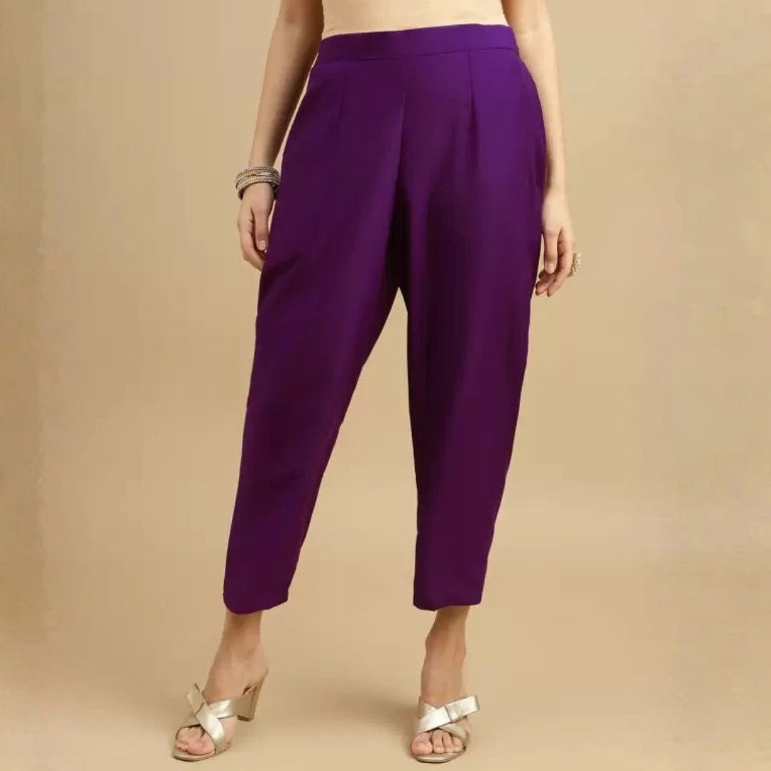 Purple pants worn by a person on a beige background