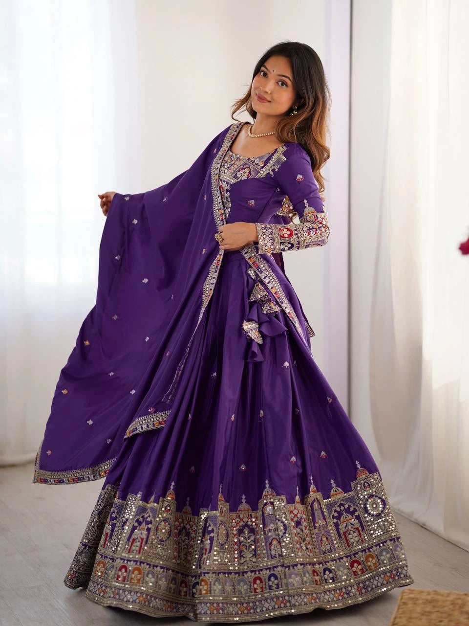 Woman wearing a purple embroidered traditional outfit with a white background