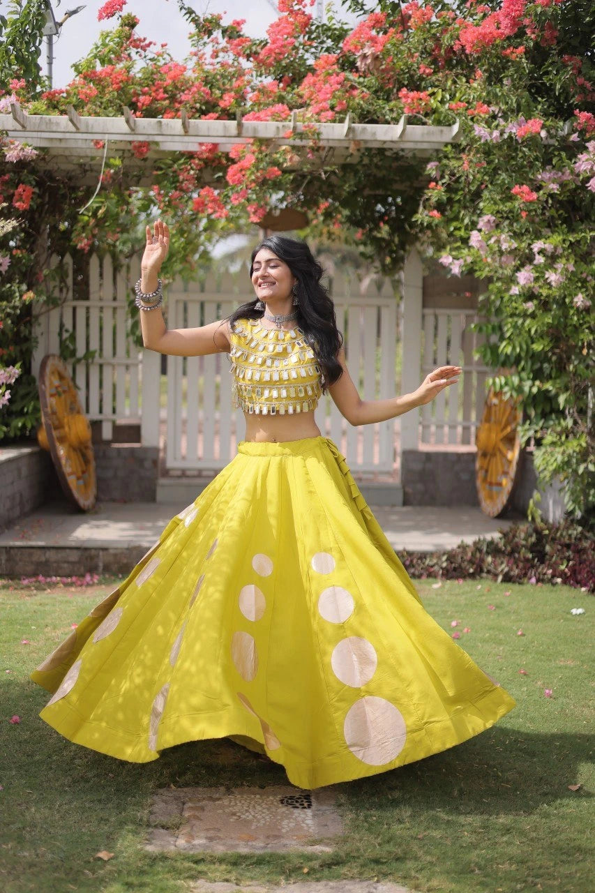 Eye-catching golden circular foil patterns add a bold and fashionable touch to the flowing yellow skirt.
