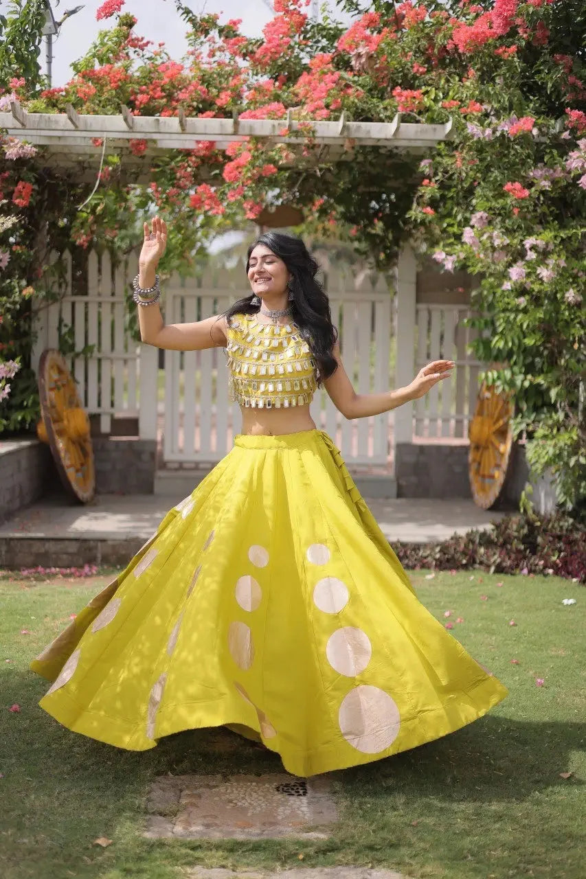 Eye-catching golden circular foil patterns add a bold and fashionable touch to the flowing yellow skirt.