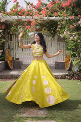 Eye-catching golden circular foil patterns add a bold and fashionable touch to the flowing yellow skirt.