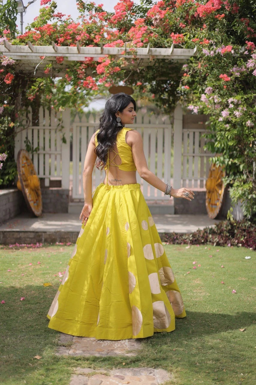 Luxurious full-length lehenga showcases premium quality fabric with striking oversized golden polka dot detailing.