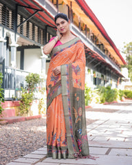 Woman wearing an orange and gray saree with a building and greenery in the background