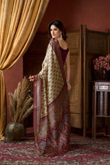 Woman in a traditional saree standing in a room with decorative elements.