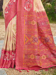 Traditional pink and beige saree with intricate patterns on a natural background
