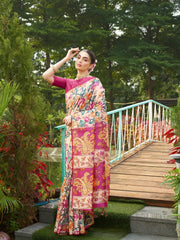 Women's beige floral saree with intricate magenta woven border and tassel pallu for festive occasions.
