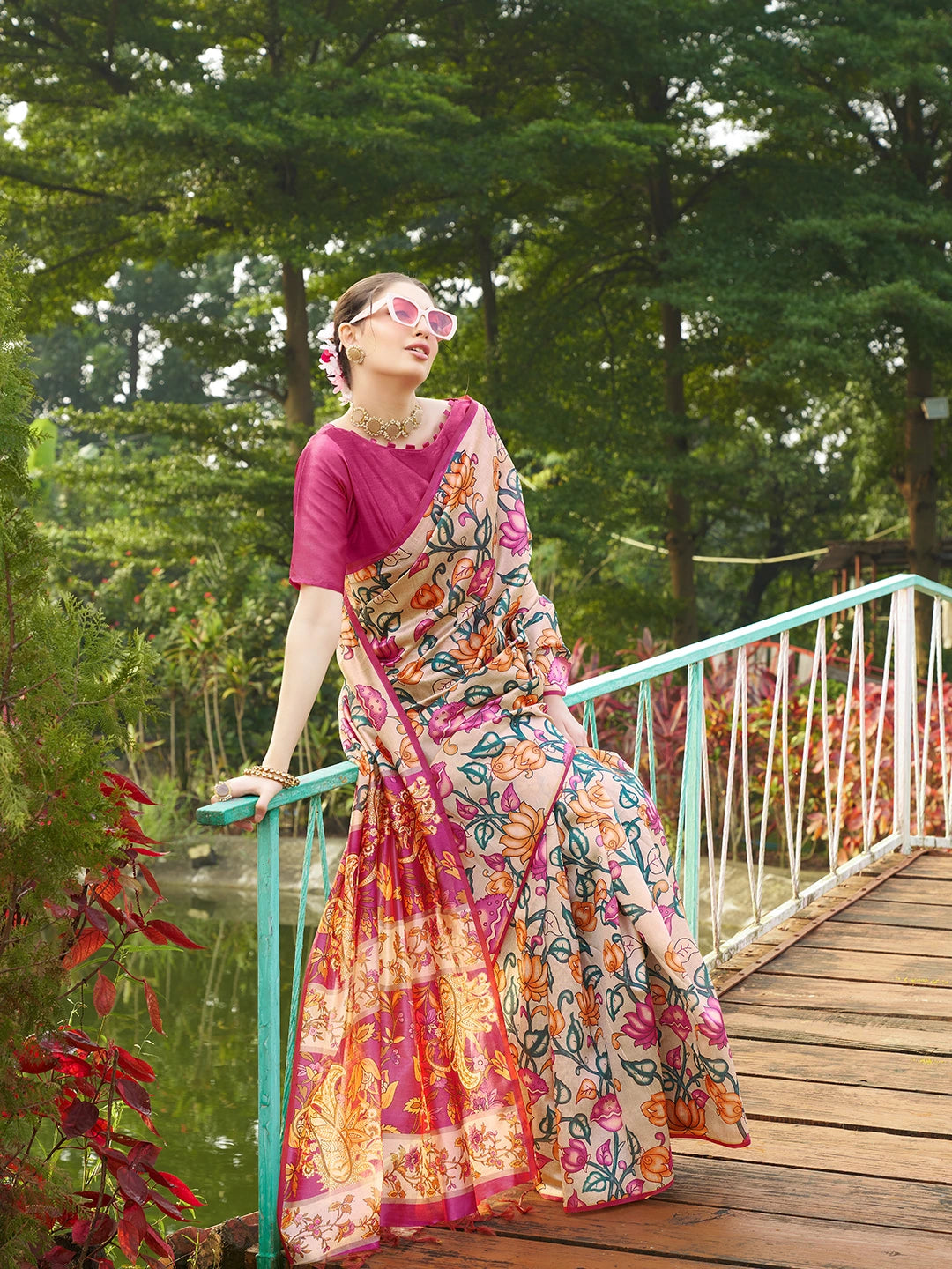 Beautiful beige floral print saree featuring a rich magenta woven pallu and traditional ethnic design.