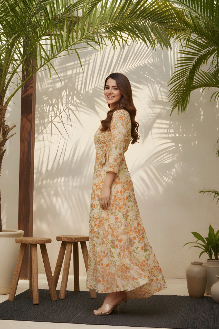 Woman in a floral dress standing under palm leaves with a neutral background