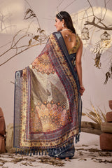 Woman wearing a traditional saree with intricate patterns in a rustic setting.