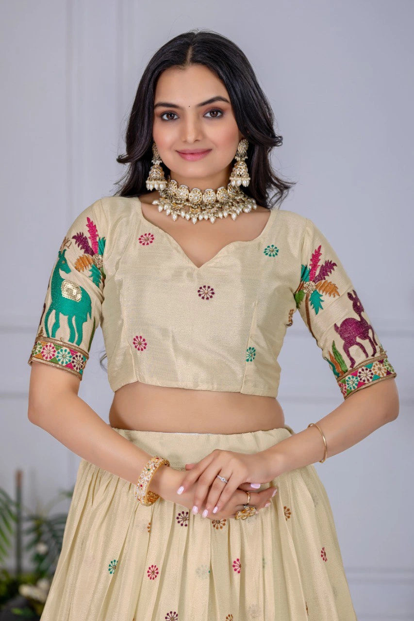 Woman wearing a traditional outfit with floral and animal patterns on a plain background