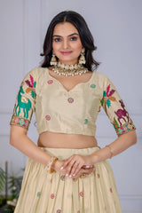 Woman wearing a traditional outfit with floral and animal patterns on a plain background