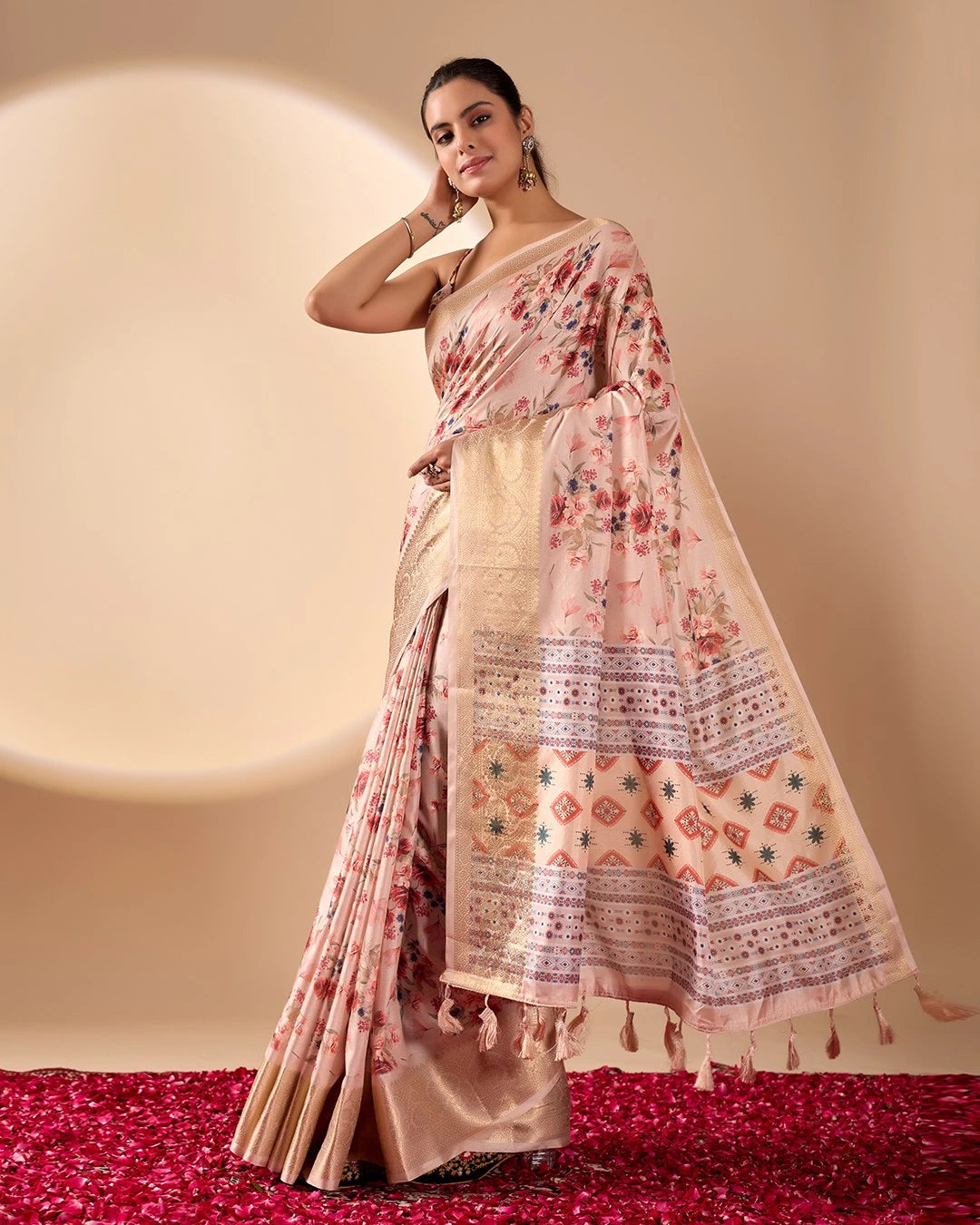 Woman wearing a floral saree with a plain background