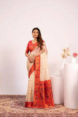 Woman wearing a saree with a red and beige pattern on a white background