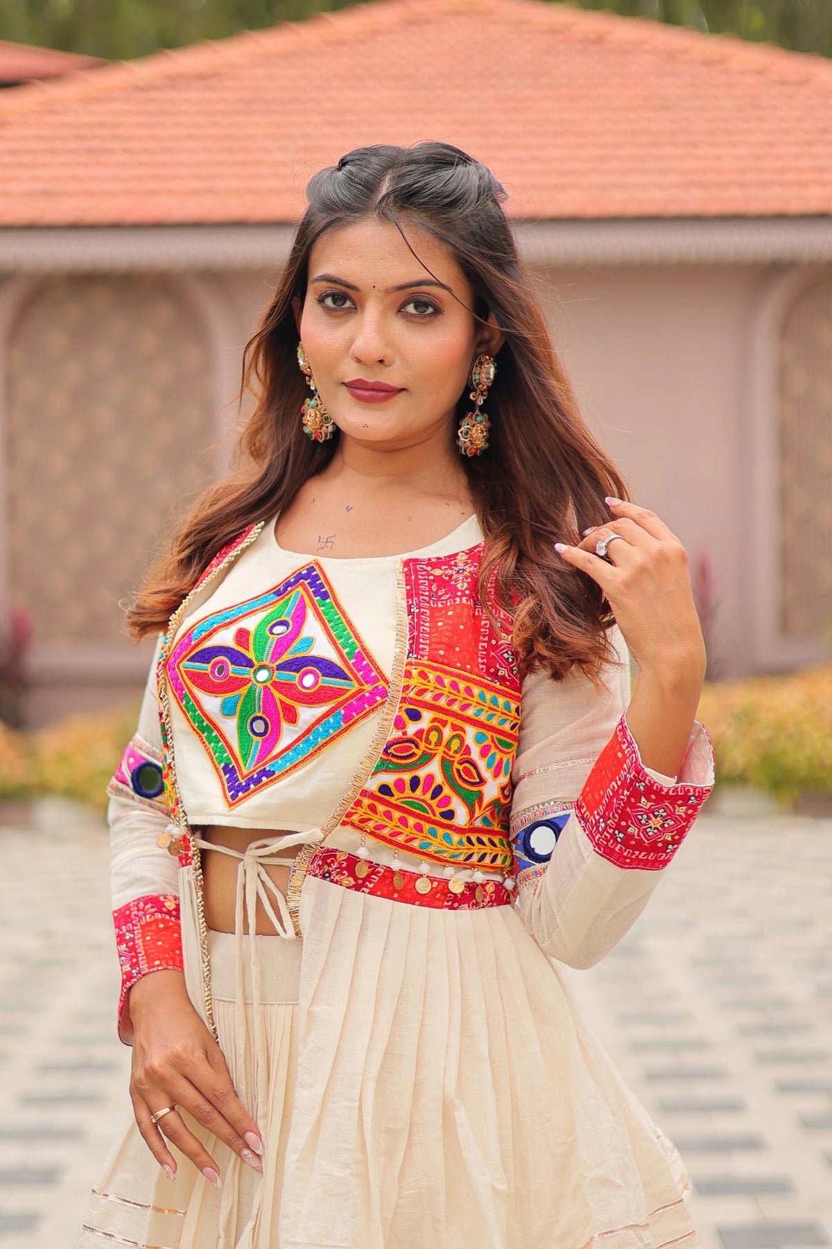 Woman wearing a traditional outfit with colorful embroidery in an outdoor setting