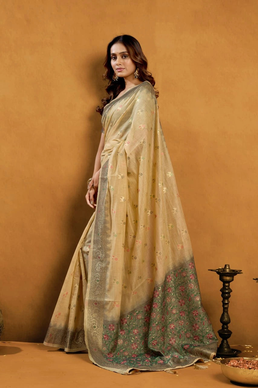 Woman wearing a beige saree with a subtle pattern against an orange background