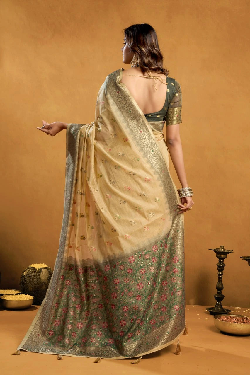 Woman wearing a traditional saree with a floral pattern against a beige background